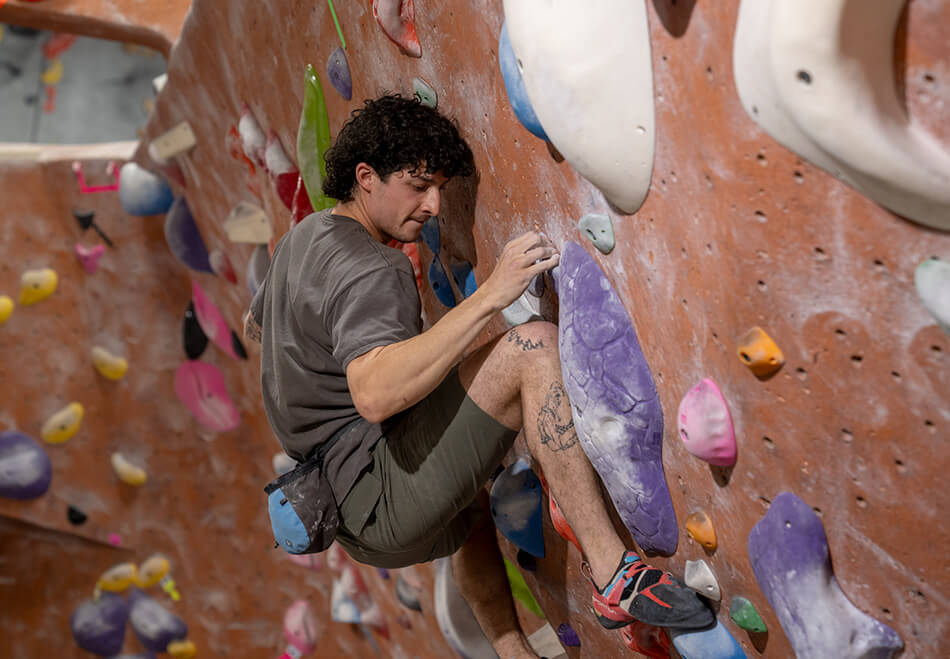 Man bouldering at Add-On Competition at NJ Rock Gym