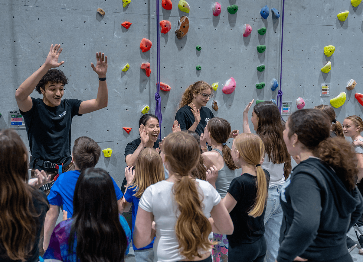 NJ Rock Gym staff giving high-fives at birthday party