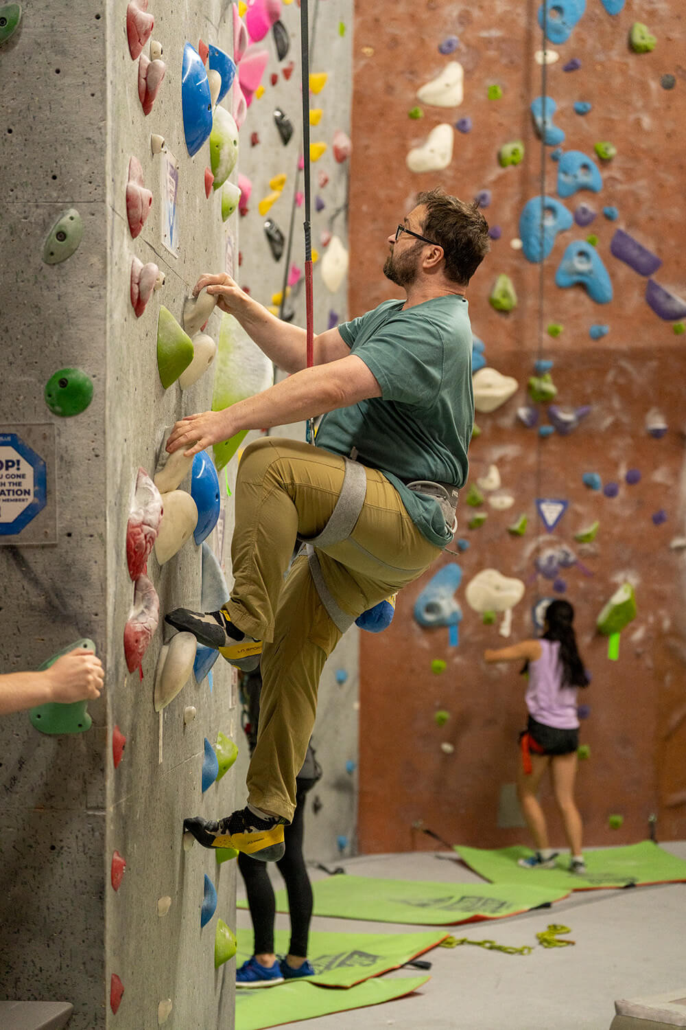 Man rock climbing on auto belay at NJ Rock Gym in Fairfield, NJ.