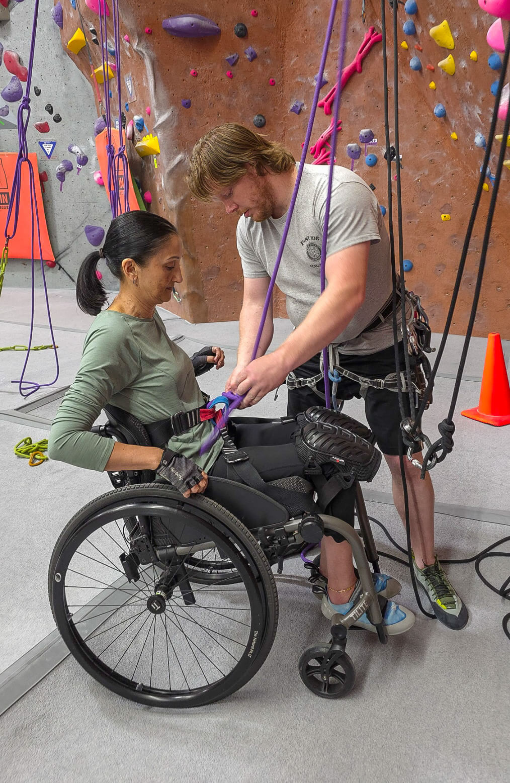 Woman in wheelchair at adaptive rock climbing event at NJ Rock Gym in Fairfield, NJ.